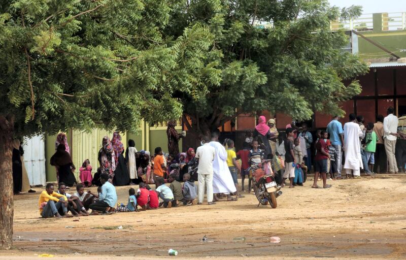 People stand in a queue on July 31, 2019 outside a bakery in the central Sudanese city of Al-Obeid, two days after five pupils were shot dead for protesting against a shortage of bread. - Tragedy struck Al-Obeid on July 29, when six people including five high school students were shot dead at a rally against a growing shortage of bread and fuel in the city.
It was the tripling of prices of bread that had triggered the initial protests against now ousted leader Omar al-Bashir in December. (Photo by ASHRAF SHAZLY / AFP)