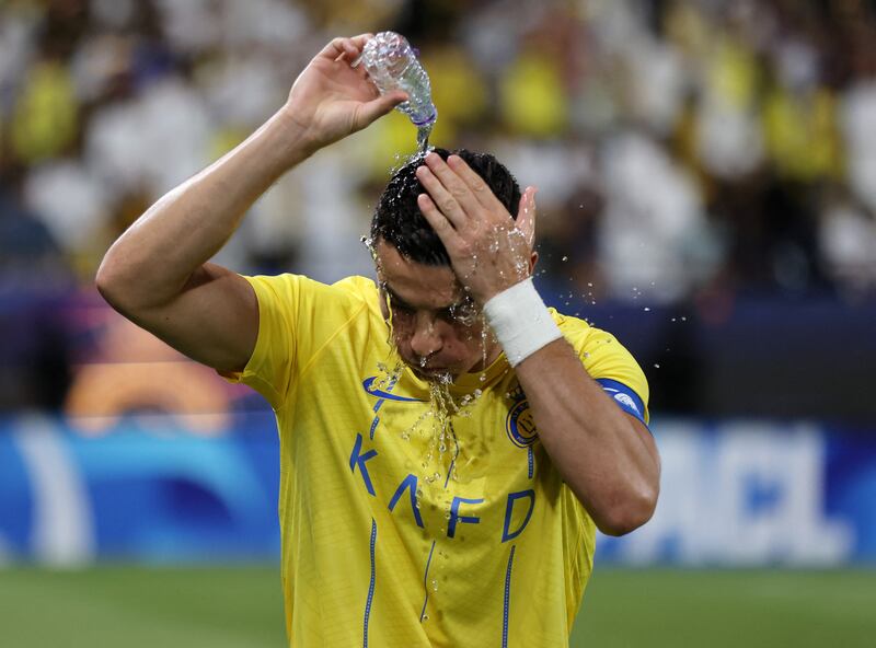 Cristiano Ronaldo pours water over his head during a break in play. Reuters
