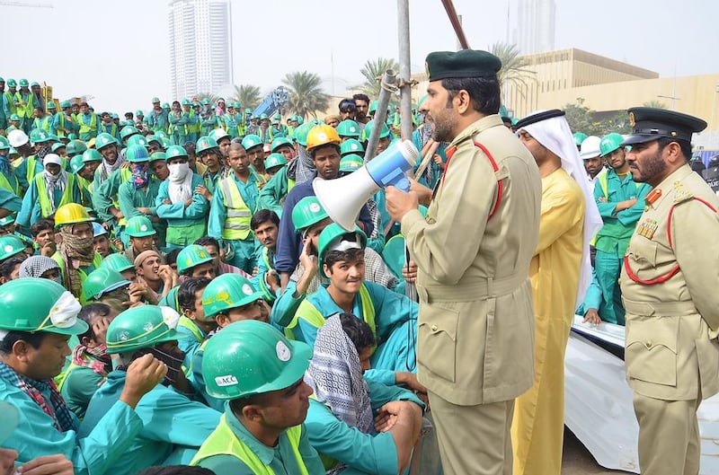 Lt Col Sultan Al Jammal, of the Human Trafficking unit at Dubai Police’s Department of Human Rights, addresses the workers. Courtesy Dubai Police