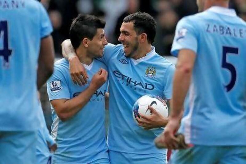 Carlos Tevez, right, has scored four goals in his last two games alongside his Argentina teammate Sergio Aguero, left. The two are likely to start up front against Wolves today at Molineux. Ian Kington / AFP