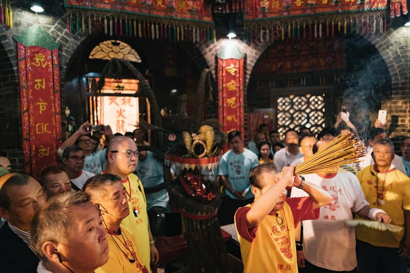 Members of the fire dragon dance team hold a lantern during the Tai Hang Fire Dragon Dance Festival.