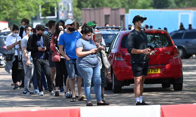 People queue up outside Twickenham rugby stadium - but not to see a match. EPA