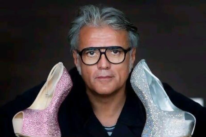 The shoe designer Giuseppe Zanotti with some of his glittering, gravity-defying creations. Jaime Puebla / The National