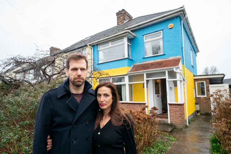 Rend Platings and her husband Michael outside their home in Cambridge on Wednesday, which they have painted in the colours of the Ukraine flag in a show of support for friends in the country. PA