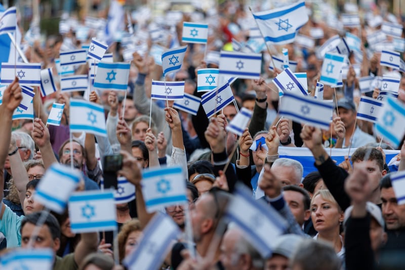 Marchers at a solidarity rally for Israel hold up flags in Nuremberg. AP