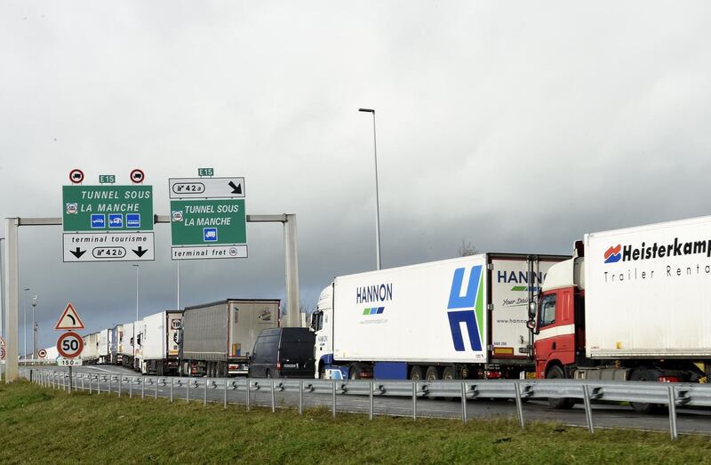 Trucks wait on the A16 motorway to board shuttles at the entrance to the Channel Tunnel site in Calais, northern France, on December 17, 2020.   Unprecedented numbers of heavy goods vehicles are seeking to cross from France to Britain ahead of the British exit from the single market this year, creating huge tailbacks around Calais, French officials said on Thursday / AFP / FRANCOIS LO PRESTI
