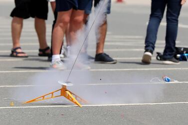 Spectators watch as a homemade rocket is launched at Dubai Parks and Resorts. Pawan Singh / The National