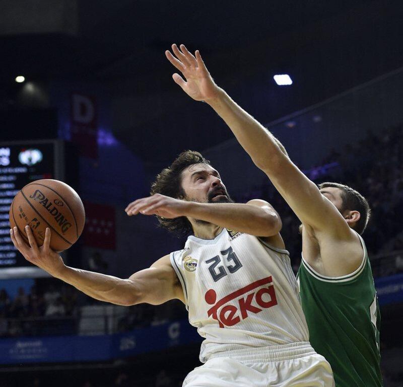 Real Madrid’s Sergio Llull tries to put up a shot against Tyler Zeller of the Boston Celtics during their pre-season game on Thursday night. Gerard Julien / AFP