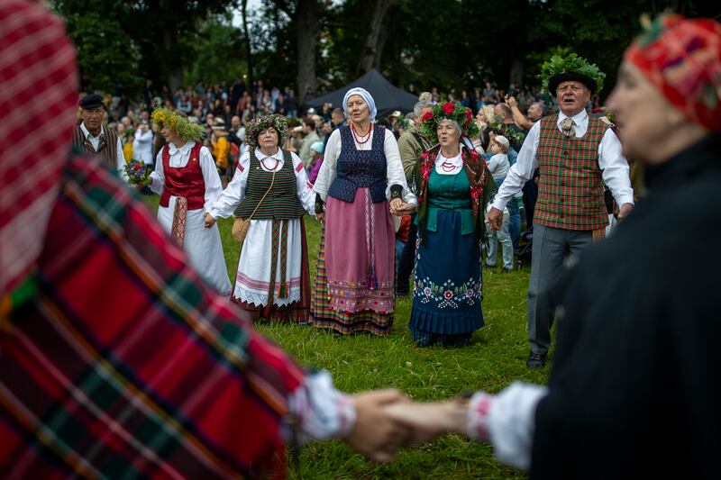 People in traditional Lithuanian clothes celebrate Saint John's Day and the summer solstice in Kernave, about 35km north-west of the capital, Vilnius. AP
