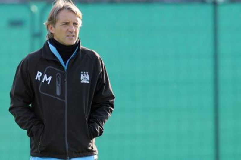 Manchester City's Italian manager Roberto Mancini attends a training session at their Carrington complex in Manchester, north-west England, on November 1, 2011 on the eve of their UEFA Champions league football match against Spanish club Villarreal in Spain. AFP PHOTO / ANDREW YATES