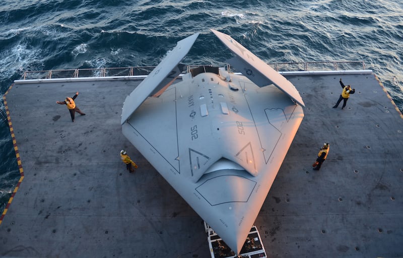 American sailors move a US Navy X-47B unmanned combat air system demonstrator on to an elevator aboard the aircraft carrier ‘USS George H.W. Bush’ in the Atlantic Ocean. The ship was the first to successfully catapult-launch an unmanned aircraft from its flight deck. Photo: US Navy