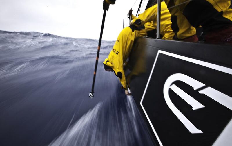 Craig Satterthwaite from New Zealand hangs over the side to tighten up some bolts in the damaged hull area while being filmed by a GoPro camera on a pole, during leg 5 of the Volvo Ocean Race 2011-2012. Nick Dana / Abu Dhabi Ocean Racing / Volvo Ocean Race photo via AP Images