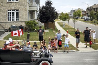 A Canada Day drive-by parade makes its way through town on July 1, 2020 in Newcastle. After living in several countries, Kareem Shaheen has settled down with his family in Canada. AFP