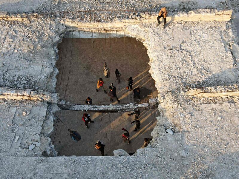 Syrian youths take part in a boxing workout held by local boxer Ahmad Dwara (unseen) inside a damaged building in the town of Atareb in the rebel-held western countryside of Syria's Aleppo province. AFP