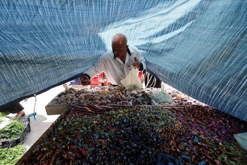 A man shops for sweets at a market before Eid Al Fitr in the port city of Sidon, Lebanon. Reuters