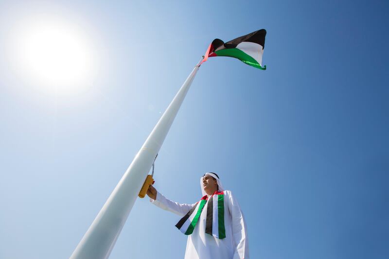 ABU DHABI, UNITED ARAB EMIRATES - November 02, 2017: ABU DHABI, UNITED ARAB EMIRATES - November 02, 2017: HE Jaber Al Suwaidi, General Director of the Crown Prince Court - Abu Dhabi (C), raises the UAE flag during a Flag Day ceremony, at the Crown Prince Court of Abu Dhabi. 
( Hamad Al Kaabi / Crown Prince Court - Abu Dhabi )
—