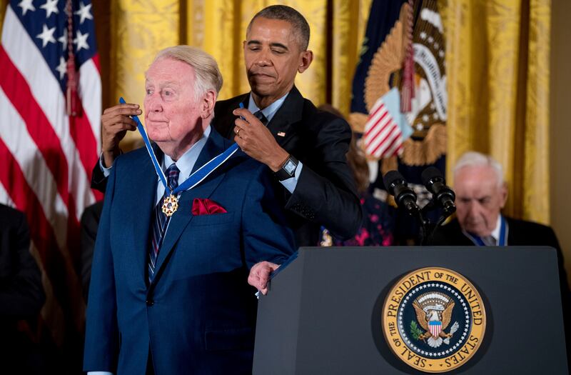 Former US president Barack Obama presents the Presidential Medal of Freedom to long-time Los Angeles Dodgers broadcaster Vin Scully in the East Room of the White House in 2016. AP