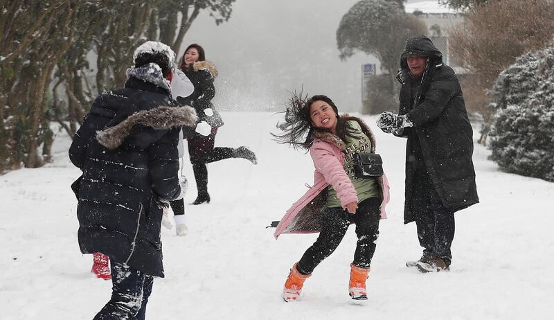 Foreign tourists participate in a snowball fight on South Korea's southern resort island of Jeju, South Korea, as heavy snow hit the area.  EPA