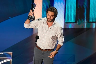 Thomas Rhett accepts the entertainer of the year award in a tie with Carrie Underwood during the 55th annual Academy of Country Music Awards at the Grand Ole Opry House on Wednesday, Sept. 16, 2020, in Nashville, Tenn. (AP Photo/Mark Humphrey)
