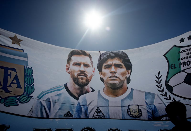 Argentina's Lionel Messi and former player Diego Maradona on a banner next to the victory parade. Reuters