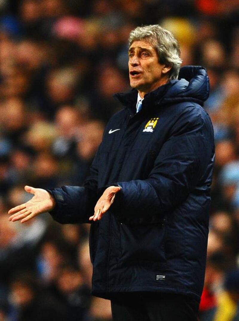 Manchester City manager Manuel Pellegrini reacts during the UEFA Champions League round of 16 first-leg match against Barcelona at the Etihad Stadium on February 18, 2014. Laurence Griffiths / Getty Images