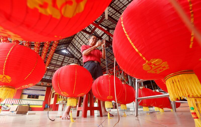 A man prepares decorative Chinese lanterns at a temple in Tangerang, Indonesia. EPA