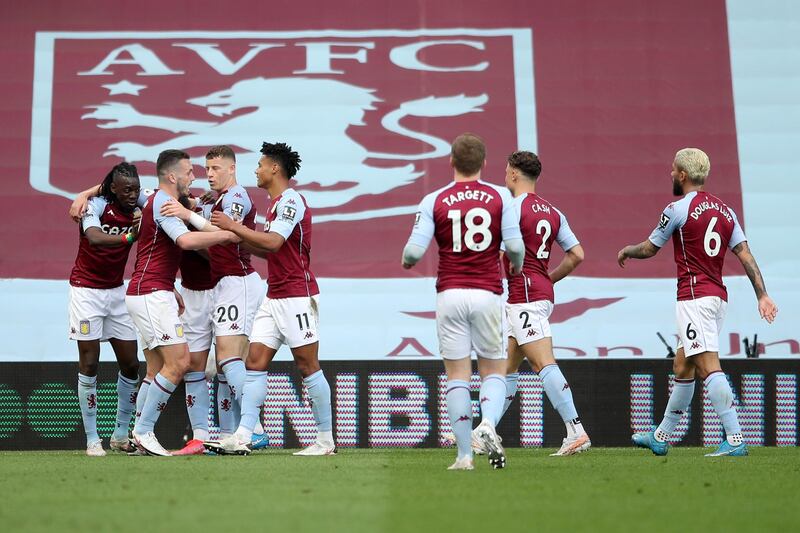 Aston Villa's Bertrand Traore, left, celebrates after scoring. AP