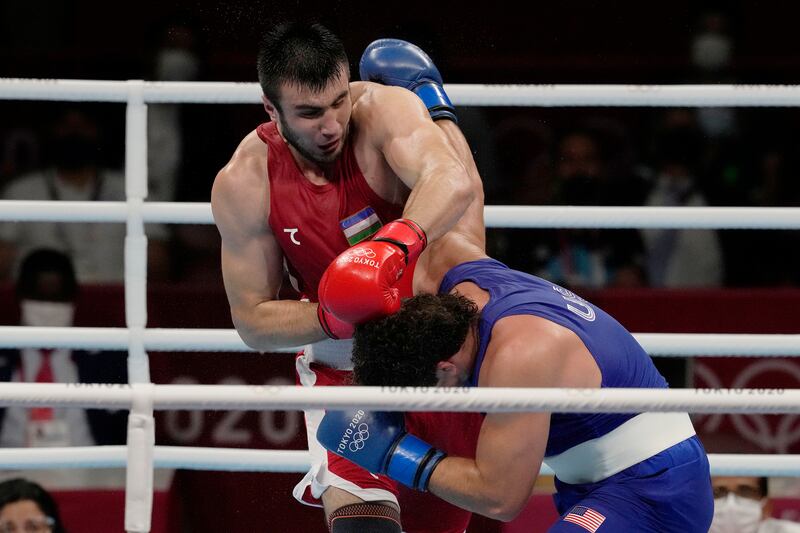 Uzbekistan's Bakhodir Jalalov, top, exchanges punches with Richard Torrez Jr from the United States during their men's super heavyweight over 91-kg boxing gold medal match.