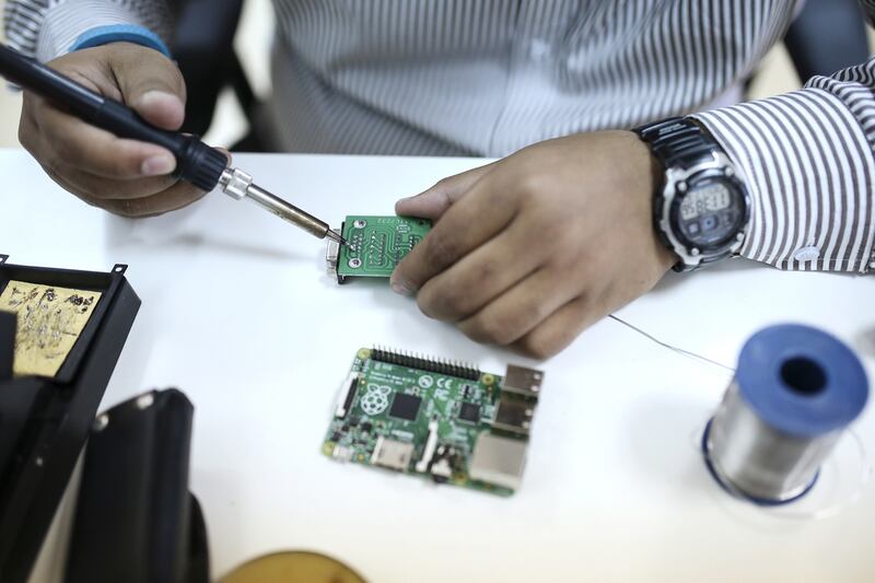 Suhail Moideen, senior hardware engineer, solders a motherboard at the Mosaikx office in Dubai. Sarah Dea / The National