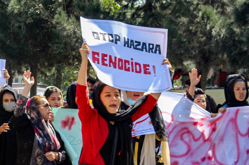 Afghan women display placards and chant slogans during a protest called ‘Stop Hazara genocide’ a day after a suicide bomb attack at a learning centre, in Kabul. AFP