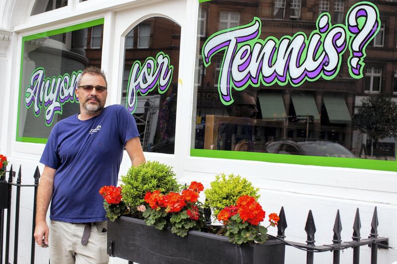 In the run up to the Wimbledon tennis championship reporter Tim Stickings and I visited and interviewed locals to guage the feeling ahead of the competition. Sign writer and local musician Mathew Swan, 43 paints 'Anyone For Tennis' on the window of the Dog and Fox pub in Wimbledon