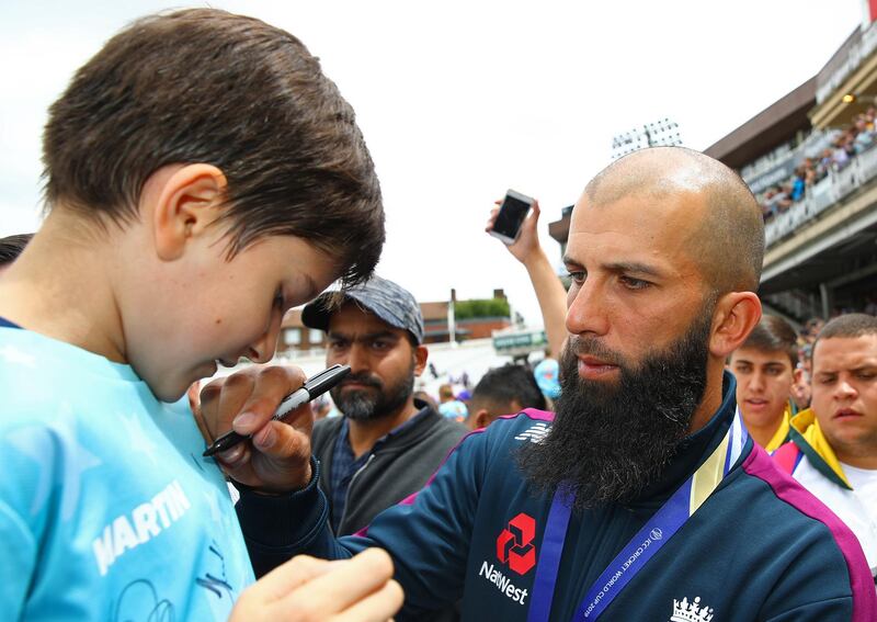 Moeen Ali of England signs a autograph during the England ICC World Cup Victory Celebration at The Kia Oval, England. Getty Images