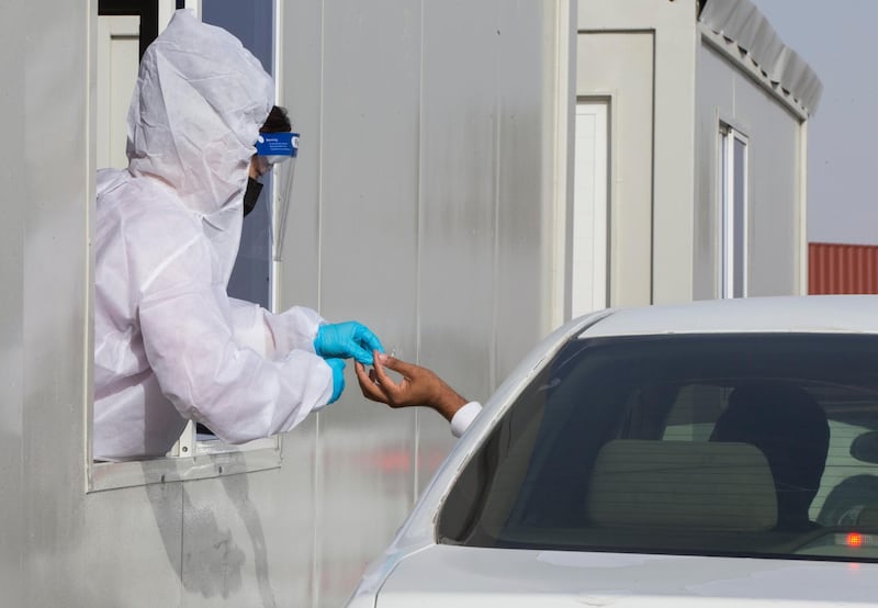 Dubai, United Arab Emirates - A passenger inside the car being tested by pricking blood sample before entering the Abu Dhabi at the new DPI Testing Centres border of Dubai and Abu Dhabi.  Leslie Pableo for The National for Shireena Al Nowais story