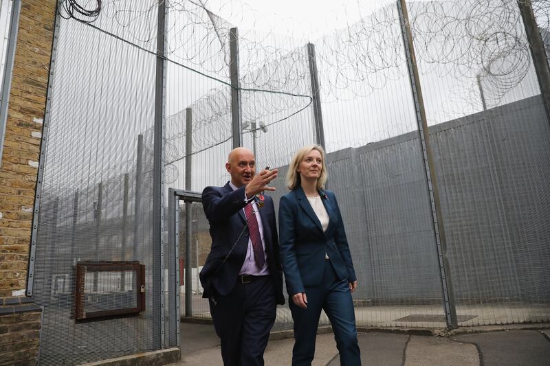Ms Truss, then secretary of state for justice, being escorted around HMP Brixton by prison governor David Bamford in November 2016.  PA