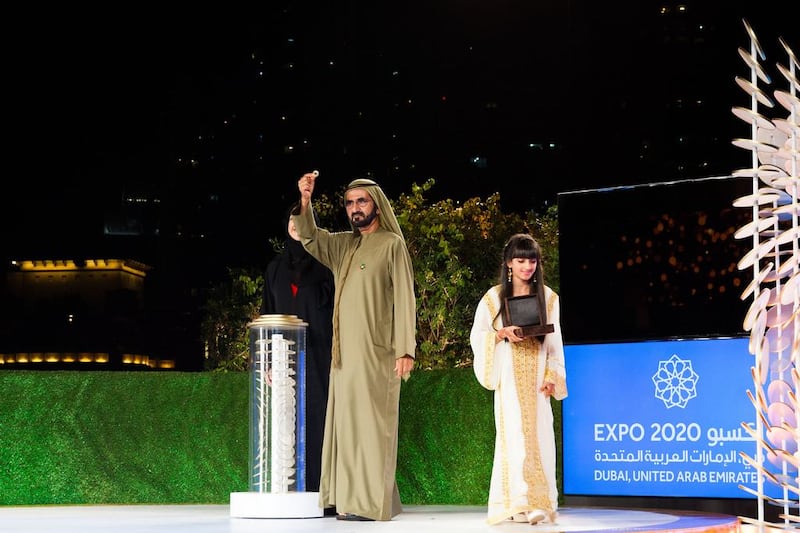 Sheikh Mohammed bin Rashid, Vice President and Ruler of Dubai holds aloft the ancient ring, which was the inspiration behind the logo for Expo 2020 Dubai. Anna Nielsen / The National
