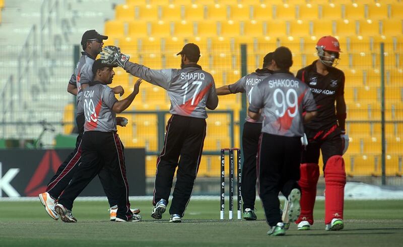 The UAE put in a brilliant bowling and fielding display against Hong Kong, in black and red, in Abu Dhabi on Tuesday. Sammy Dallal / The National