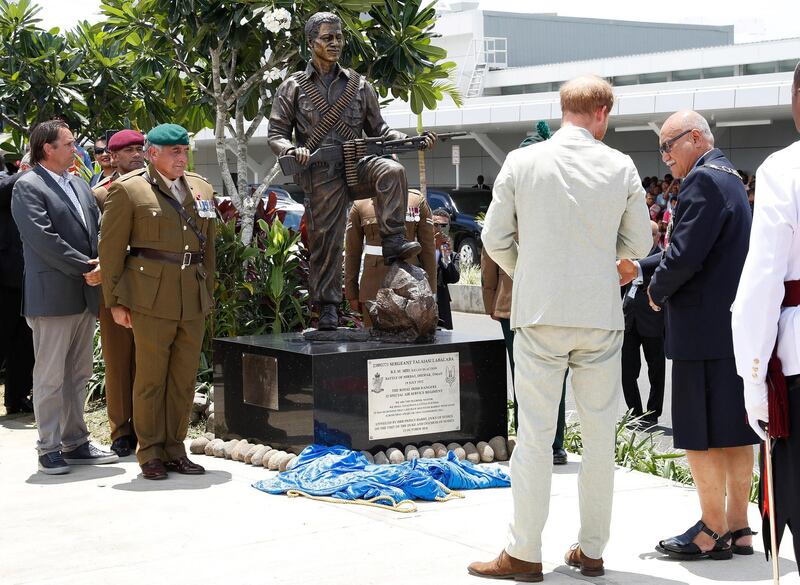 Britain's Prince Harry and Fiji's President Jioji Konrote stand in front of a new statue commemorating Sergeant Talaiasi Labalaba, a British-Fijian soldier who lost his life in the 1972 Battle of Mirbat. Reuters