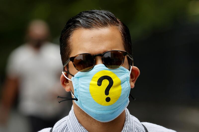 A man wears a protective face mask decorated with a question mark in lower Manhattan during the outbreak of the coronavirus disease (COID-19) in New York, U.S., May 22, 2020. Picture taken May 22, 2020. REUTERS/Mike Segar     TPX IMAGES OF THE DAY