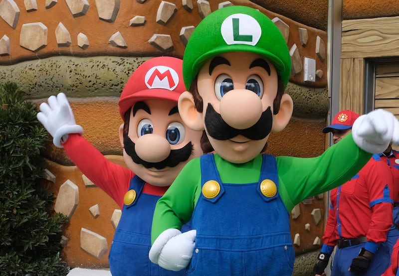 Mario and Luigi wave to the guests