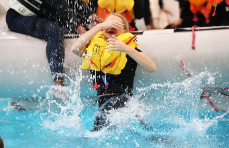 Despite being taught to stay in the inflatable life raft, trainees are asked to jump in the cold water during emergency landing exercises to learn the proper technique for keeping warm.