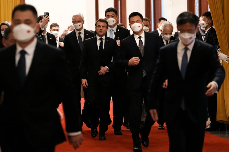 Mr Macron arrives for a meeting with Chinese Premier Li Qiang in Beijing. AP