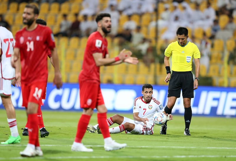 UAE's Ali Saleh with the ball after drawing a foul against Bahrain.