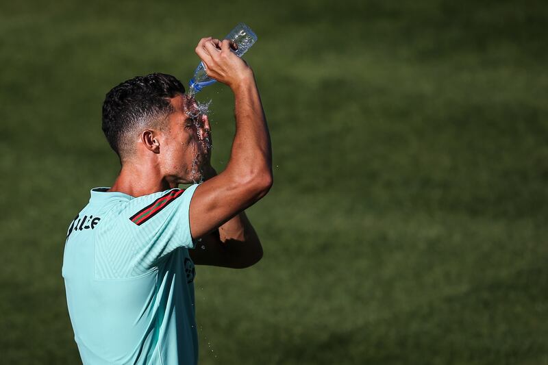 Cristiano Ronaldo cools off at training. EPA