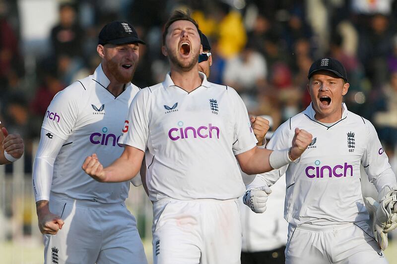 England bowler Ollie Robinson celebrates after taking the wicket of Pakistan's Salman Ali Agha. AFP