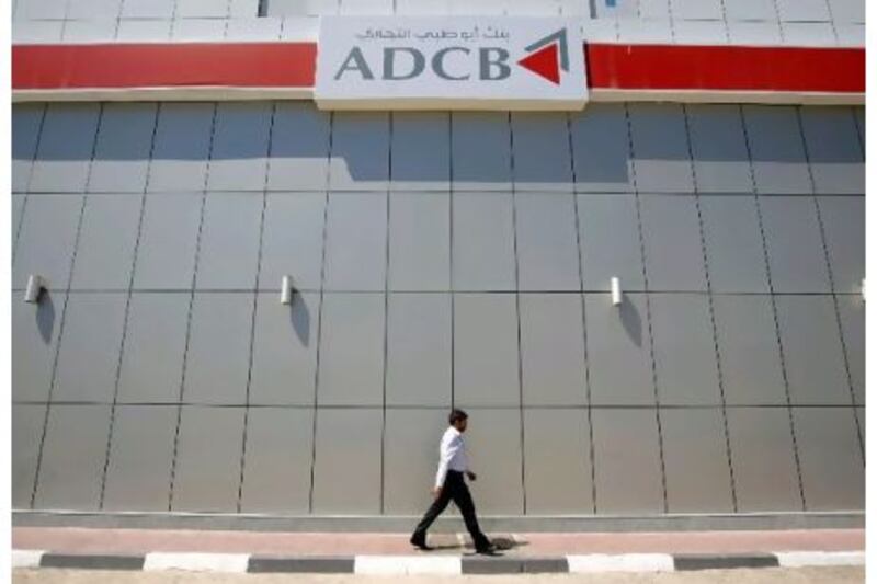 A Dh1.3bn asset sale helped Abu Dhabi Commercial Bank creep back into profit in the second quarter of the year.