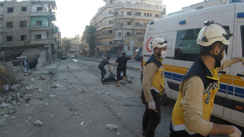 Men pick up a victim as White Helmets work in the aftermath of a Syrian army bombardment of residential areas in rebel-held Ariha, Idlib, Syria October 20, 2021. Photo: White Helmets