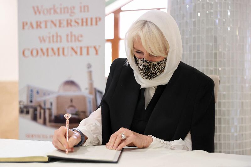 Camilla, Duchess of Cornwall signs the visitors' book during her visit to Wightman Road Mosque in north London. AFP