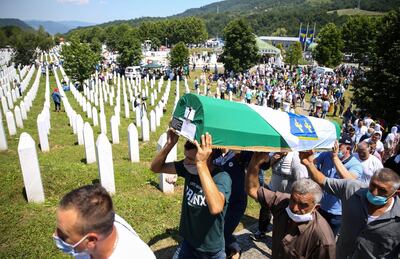 Men carry a coffin at a graveyard during a mass funeral in Potocari near Srebrenica, Bosnia and Herzegovina July 11, 2020. Bosnia marks the 25th anniversary of the massacre of more than 8,000 Bosnian Muslim men and boys, with many relatives unable to attend due to the coronavirus disease (COVID-19) outbreak. REUTERS/Dado Ruvic