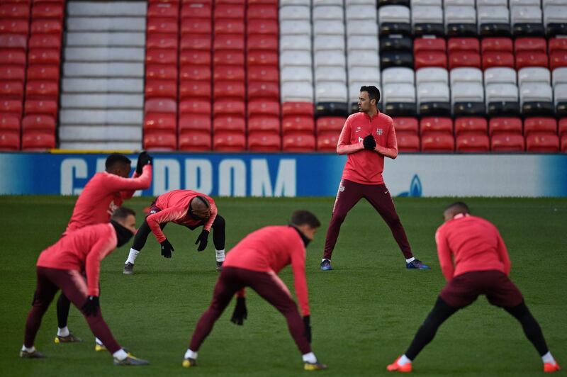 Barcelona's Spanish midfielder Sergio Busquets (2nd R) and teammates attend a training session at Old Trafford stadium in Manchester, north west England on the eve of their UEFA Champions League quarter final first leg football match against Manchester United.  AFP