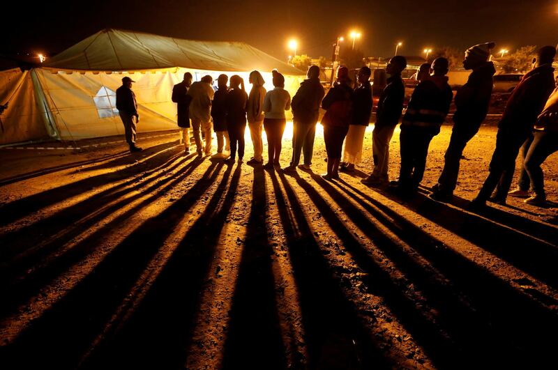 Voters queue to cast their ballots before polls close outside a polling station in Alexandra township in Johannesburg, South Africa. Reuters